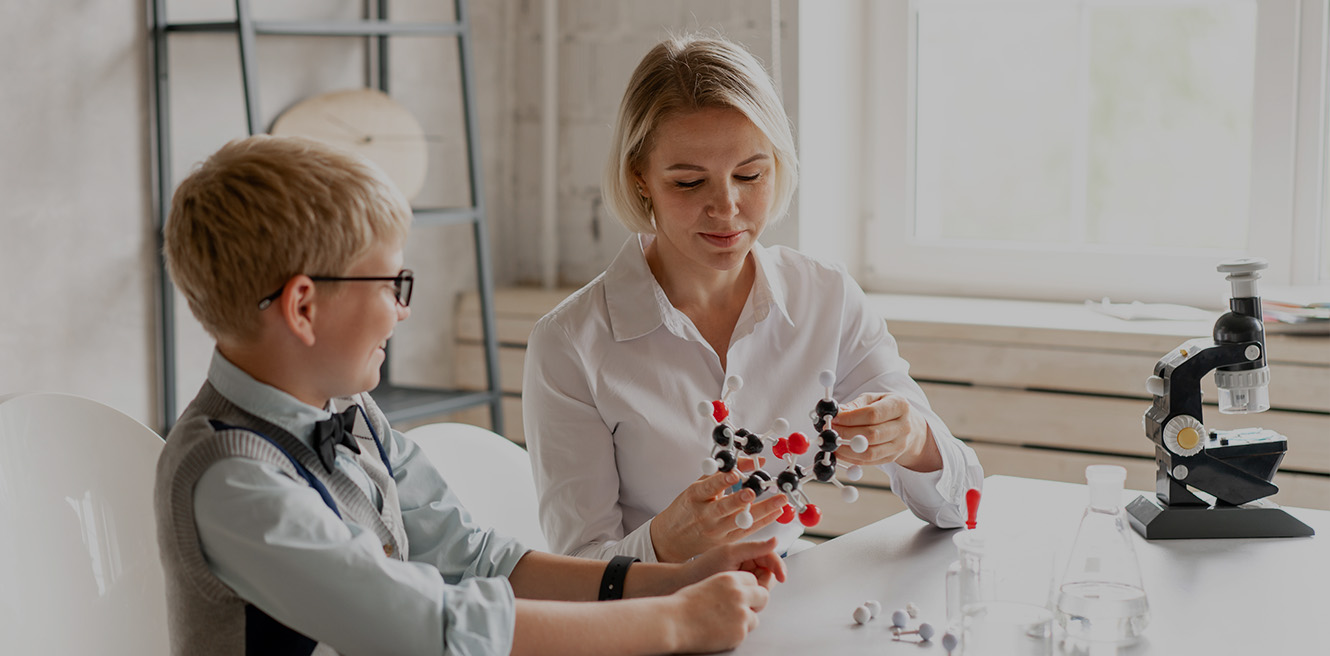 Female science tutor in Phoenix studying chemistry with student